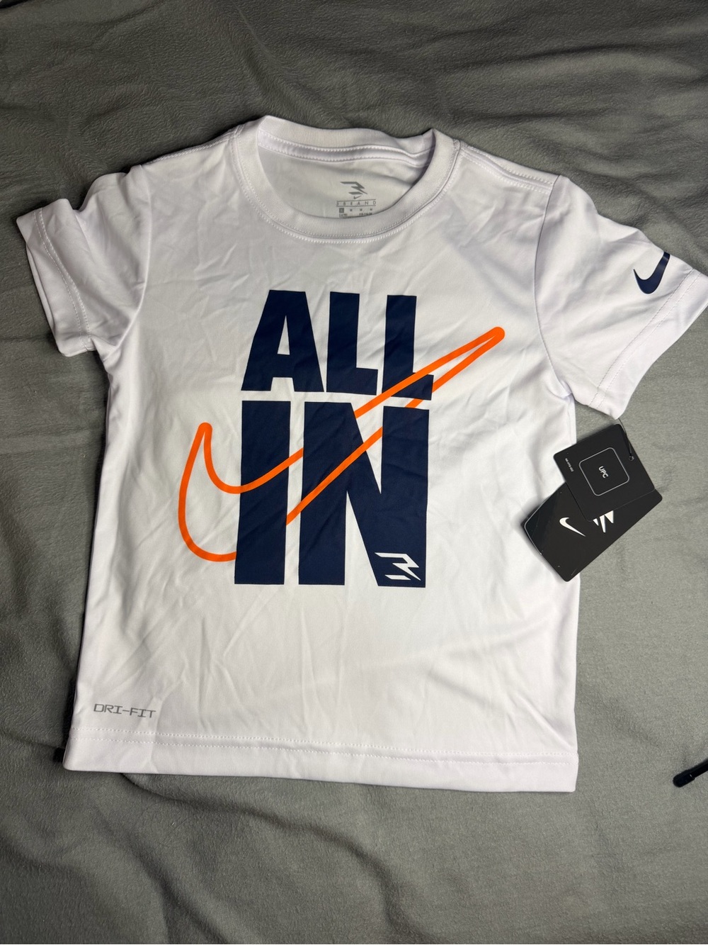 Nike Kids White Tee with Navy 'ALL IN' and Orange Swoosh